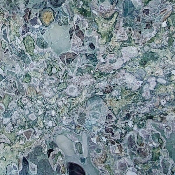 Conglomerate stone slab with vibrant natural patterns and mixed fragments, perfect for luxury interiors and decorative features.