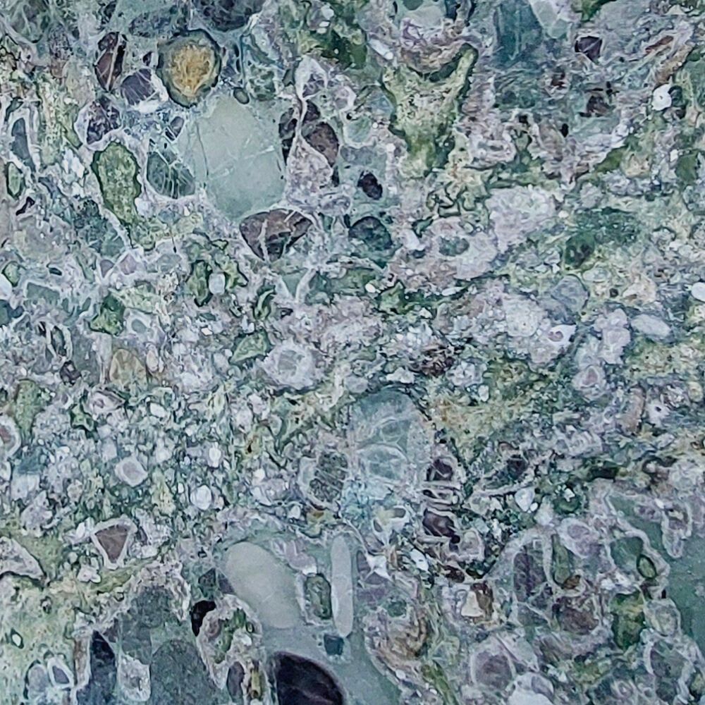 Conglomerate stone slab with vibrant natural patterns and mixed fragments, perfect for luxury interiors and decorative features.