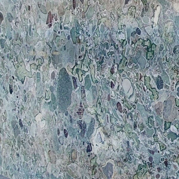 Conglomerate stone slab with vibrant natural patterns and mixed fragments, perfect for luxury interiors and decorative features.