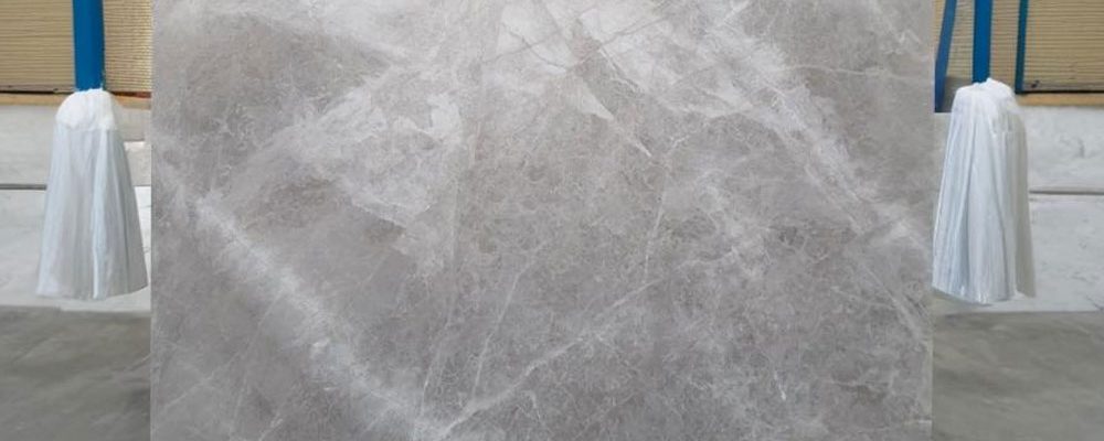 Close-up of Persian Silk Marble slab showing soft cream and beige veins
